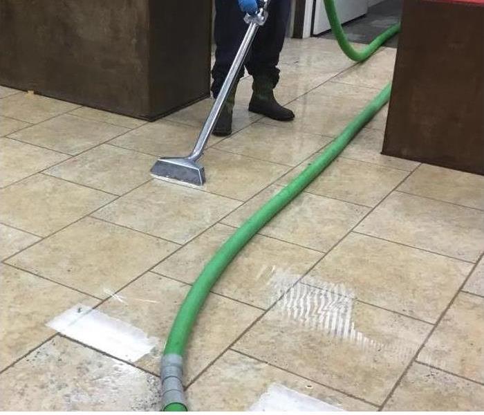 Cleaning standing water in commercial building.
